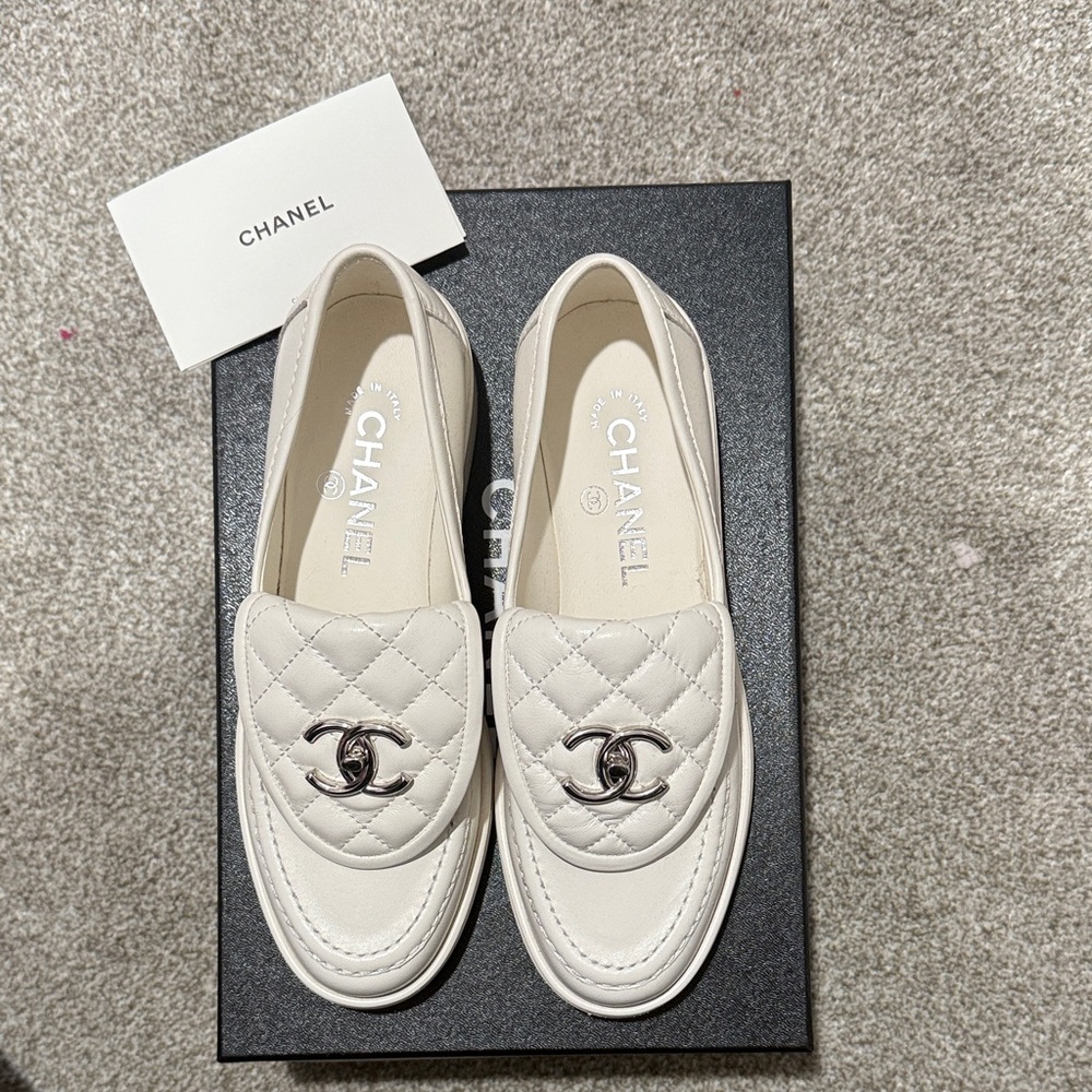 CHANEL Cream Quilted Loafers with Silver Logo